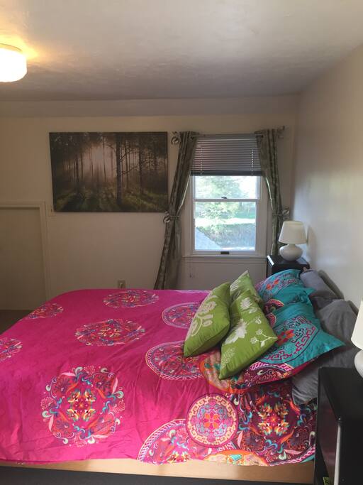 Bedroom to the right of the top of the stairs with queen bed.