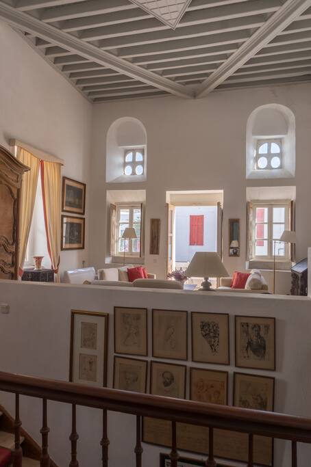 The living room with abundant natural light entering the double height space