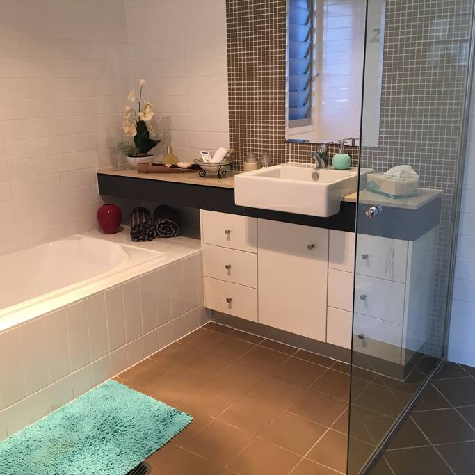 Beautiful modern private bathroom with shower and bath.