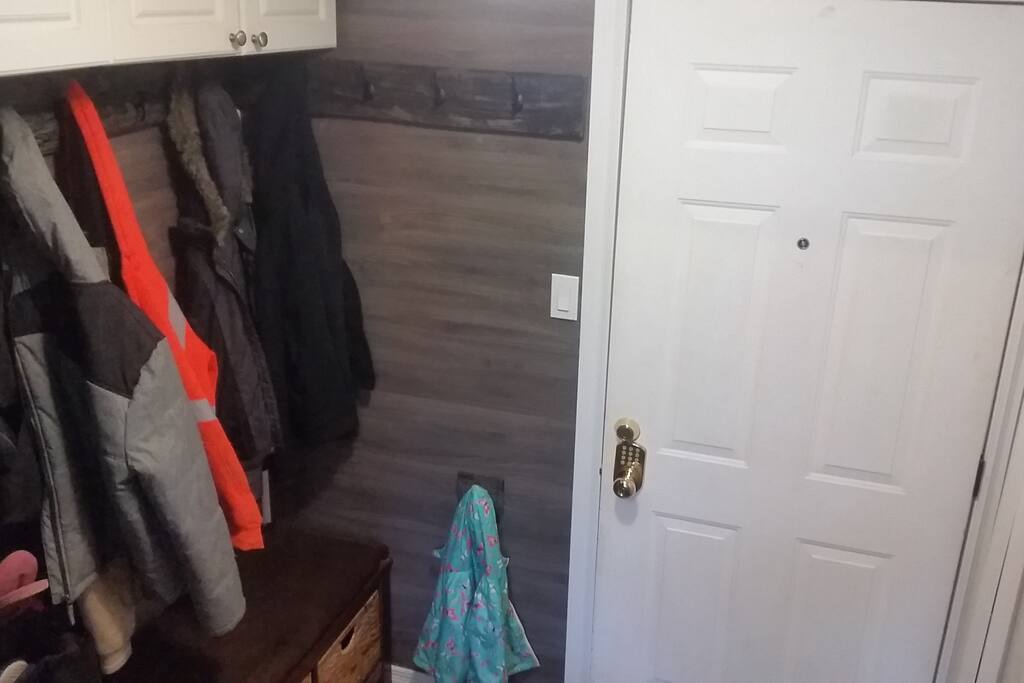 Entrance with shoe and jacket storage. 7 stairs down to unit door.