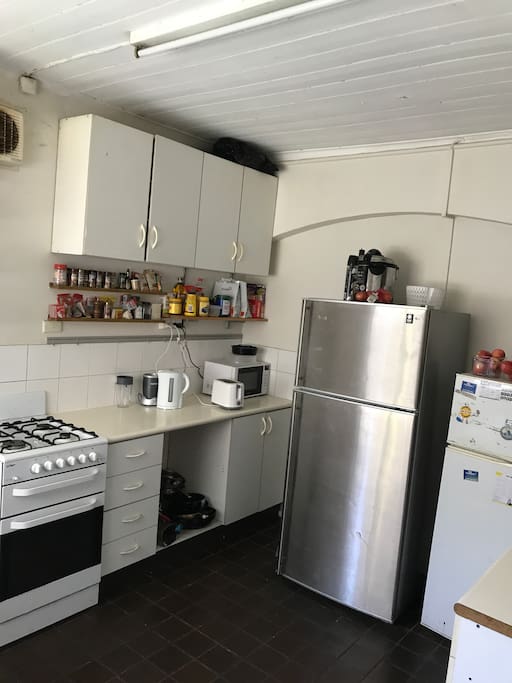 Shred kitchen with fridges, gas stove top, gas oven and all plates/cooking equipment
