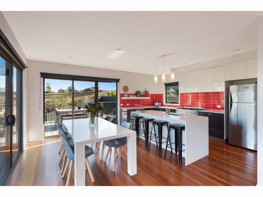Dining and kitchen with double access on to deck.