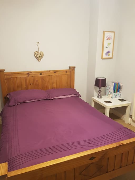 Double bed. Wooden rail for clothes also provided in room.