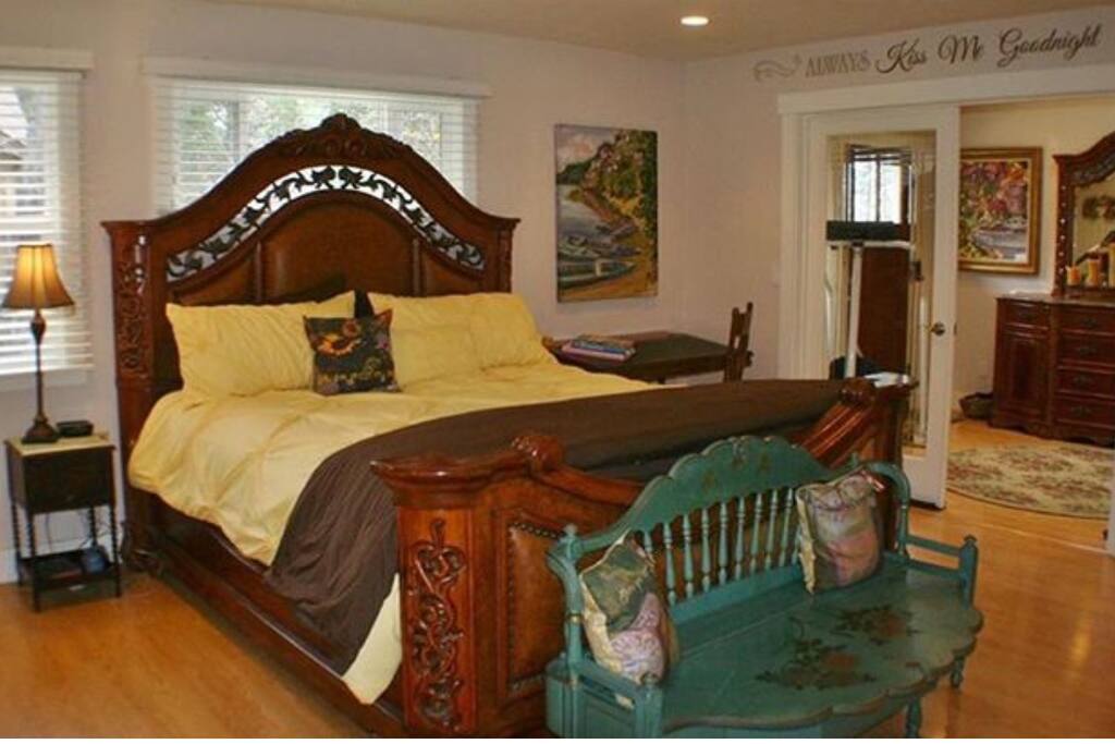 Master bedroom, with king size bed and TV.