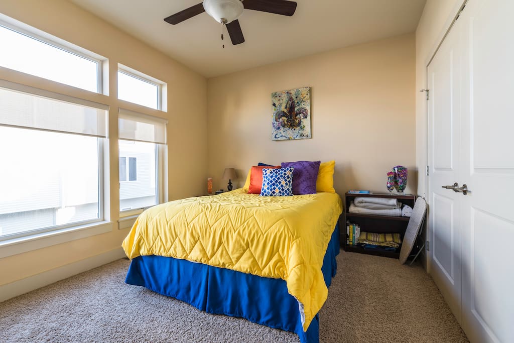 Your room with large windows with plenty of light, space in closet to hang clothes, iron and ironing board in room as well.