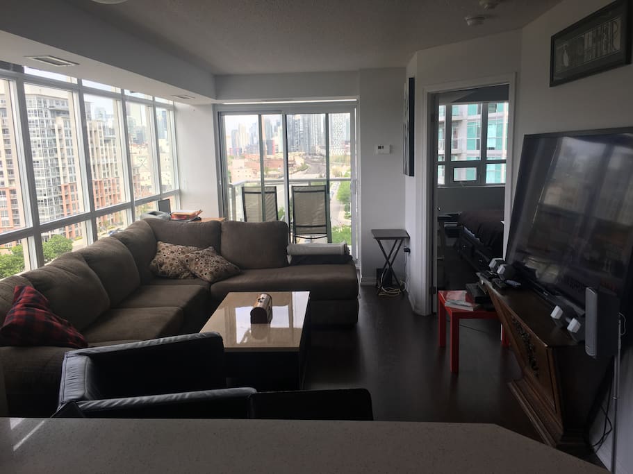 Large living area with sectional couch and 72 inch tv