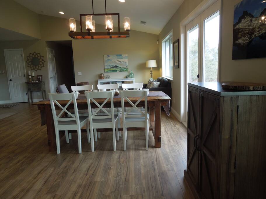 Enjoy a meal at the large rustic dining room table made from local reclaimed barn wood.