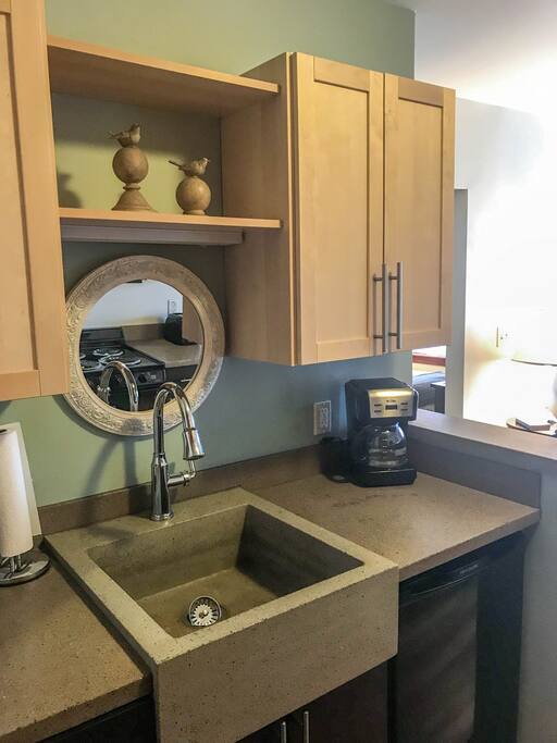 The kitchen includes a stove, oven, microwave, coffee maker, toaster, and dishes.