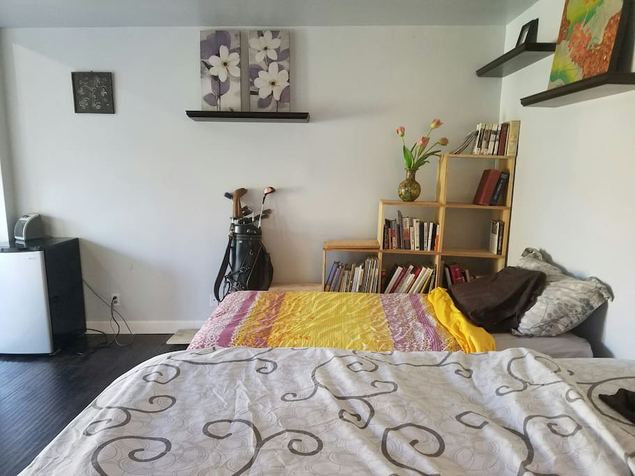 Bedroom. Two beds, one queen one twin. Books, golfing equipment, fridge...etc