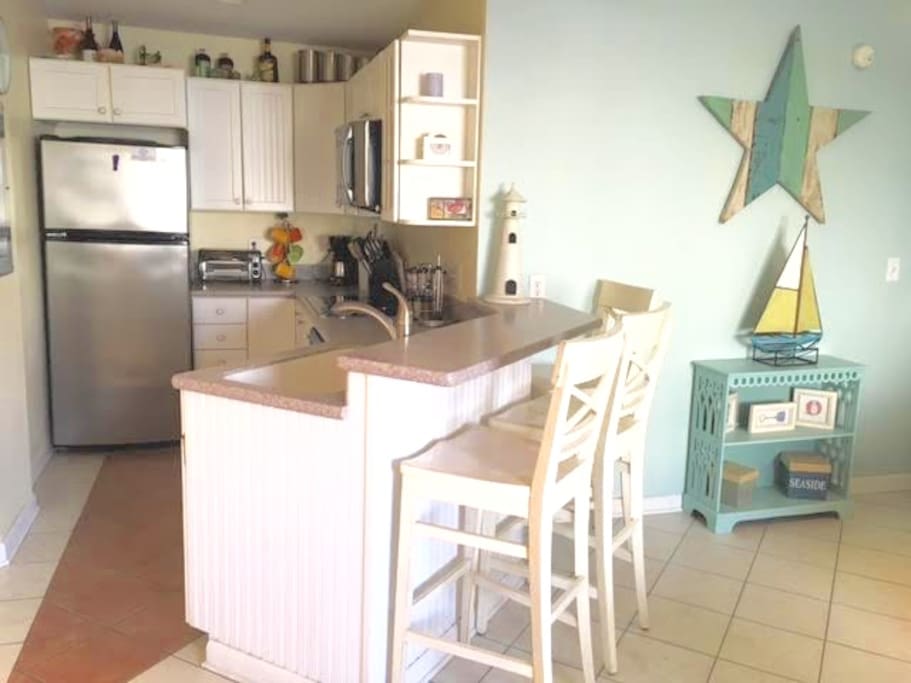 Kitchen w corian counters and stainless appliances