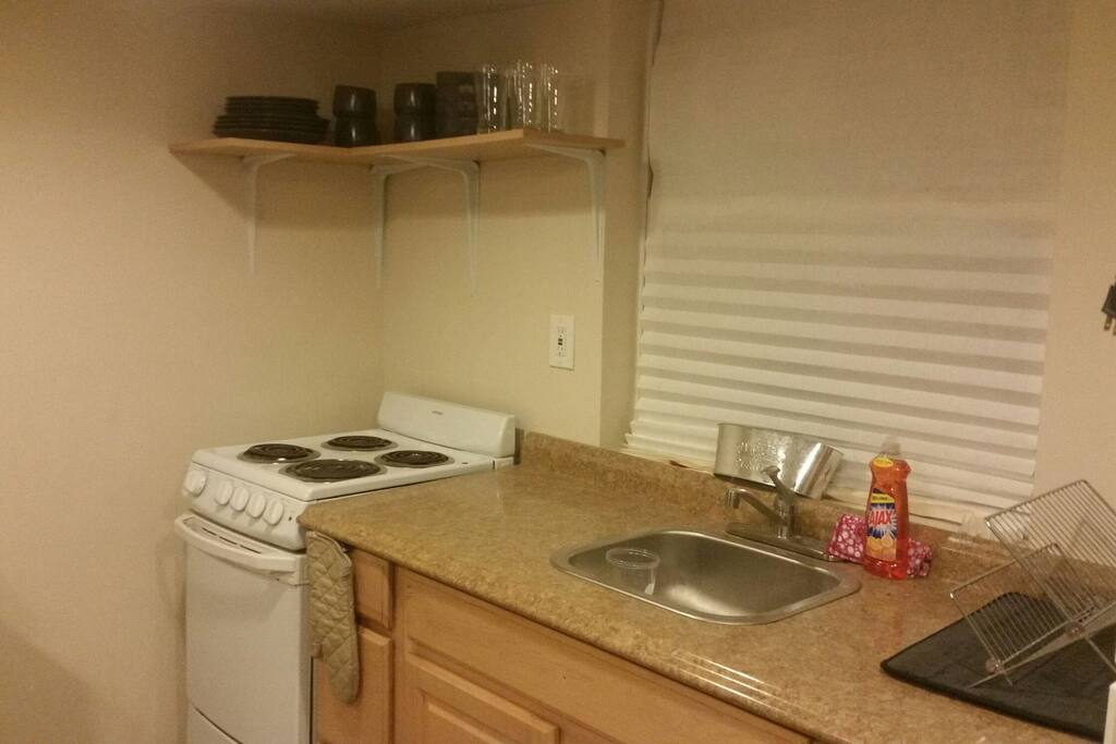 New dinnerware and glasses for your use. Flatware is in drawers below. Pots and pans and under the sink.