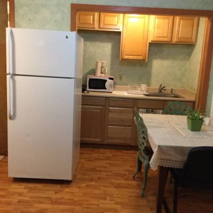 full refrigerator, microwave, coffeemaker, hot plate, includes silverware, dishes, pots
