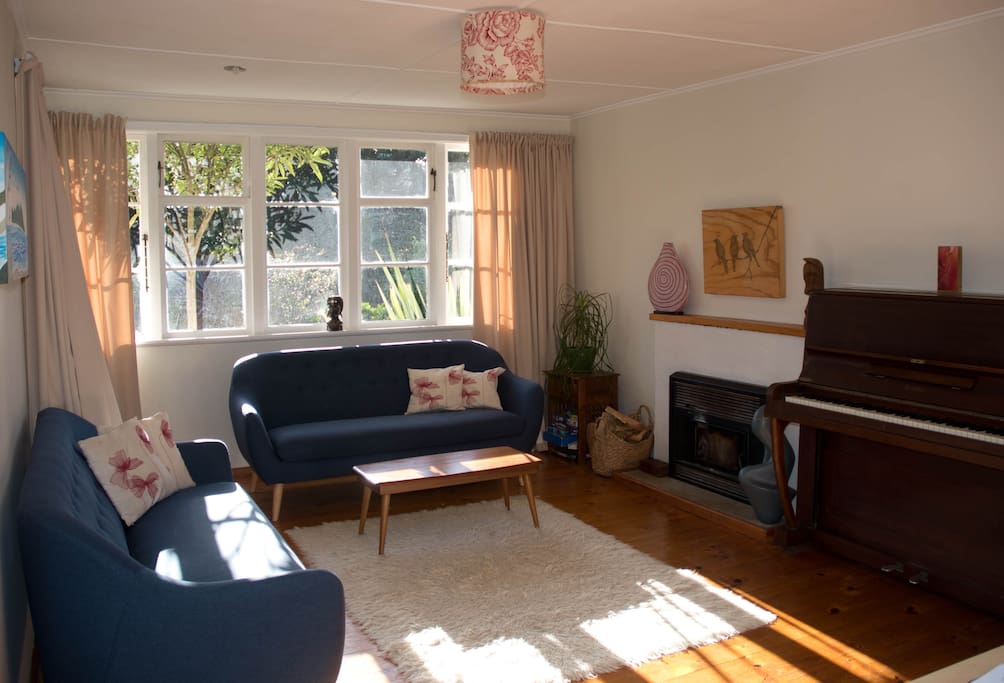 Open plan lounge with fireplace and heat pump