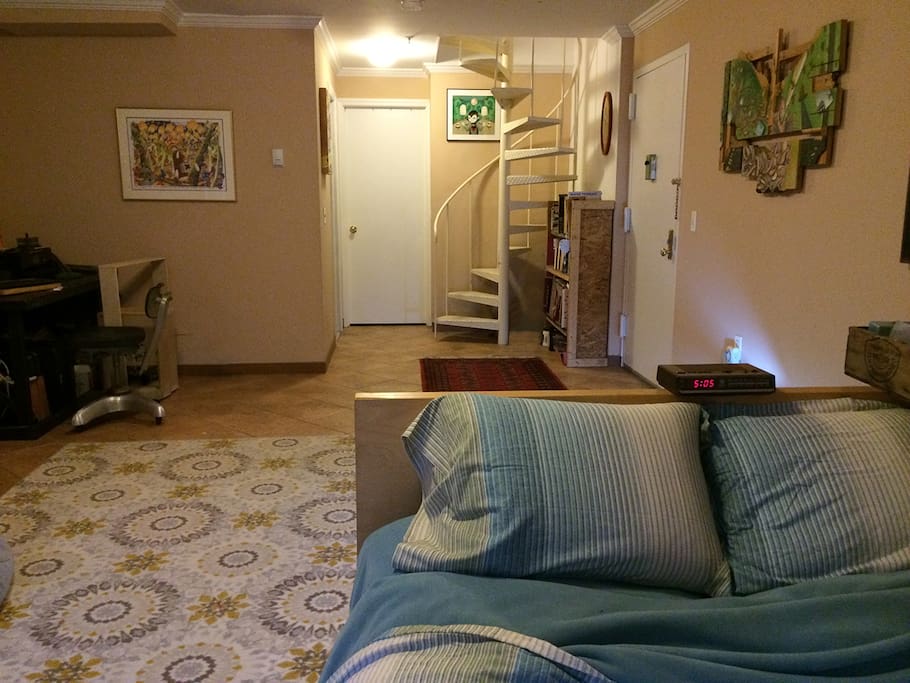 Downstairs bedroom, with stairs to kitchen and living room upstairs.