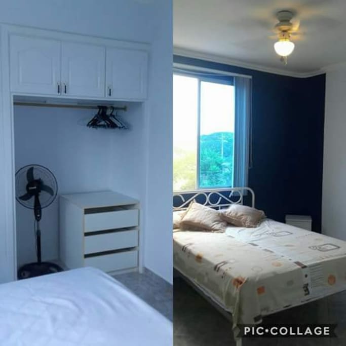 Dormitorio 1 con closet, velador, ventilador de techo y ventilador de pedestal.