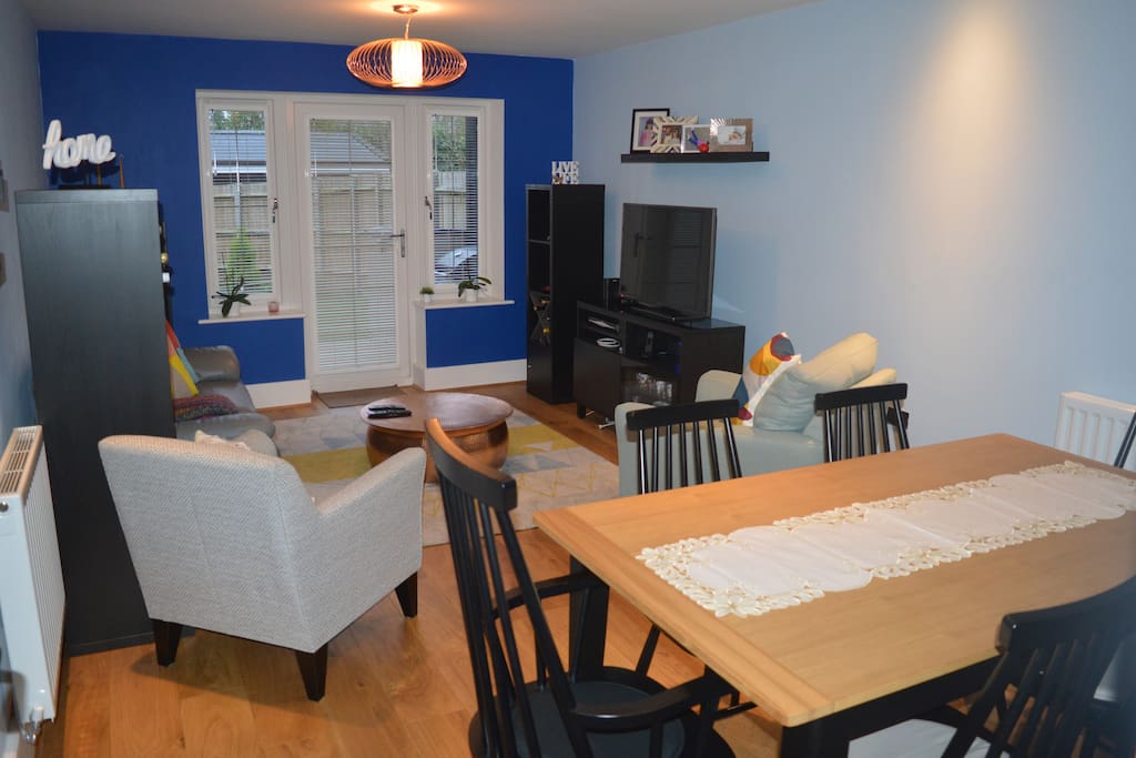 Spacious common lounge with dinning table, TV and access to the garden