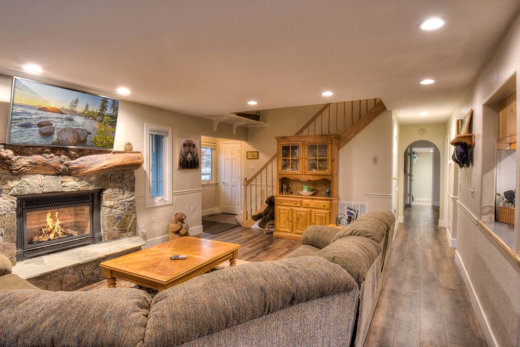 Living room with stone fireplace and flatscreen TV