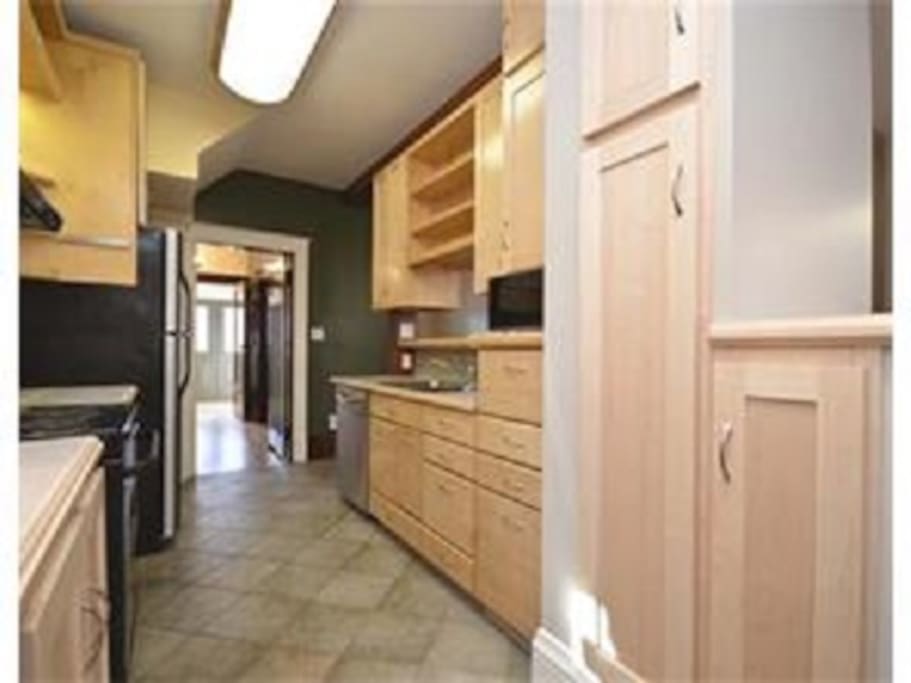 Kitchen opens into Dining room with bar stools.