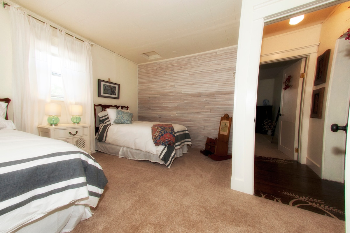 Twin bed room. Salvaged and repurposed boards make for a beautiful shiplap wall.