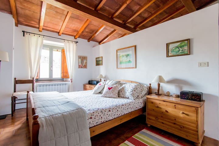 The master bedroom.
The wall behind the bed divides the bedroom from the bathroom,  it does not fully reach the ceiling!  Done on purpose NOT to ruin the view of the beautiful wooden beams!
The Bathroom is only accessible through the master bedroom.