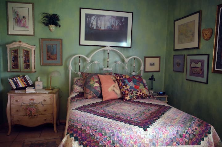 La cama de hierro vintage está decorada con una colcha casera.