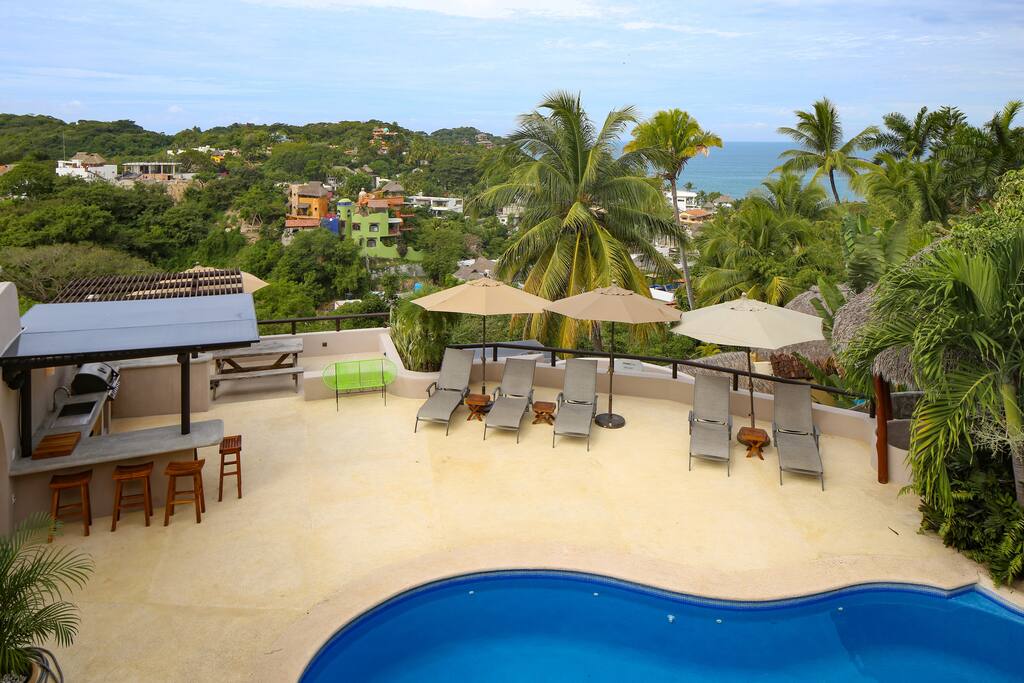 Pool terrace and outdoor kitchen viewed from the palapa terrace