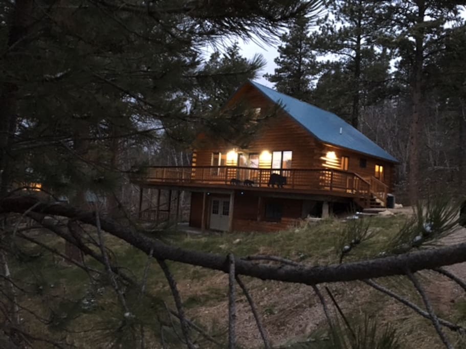 Front view of the Log Cabin with wrap around deck.