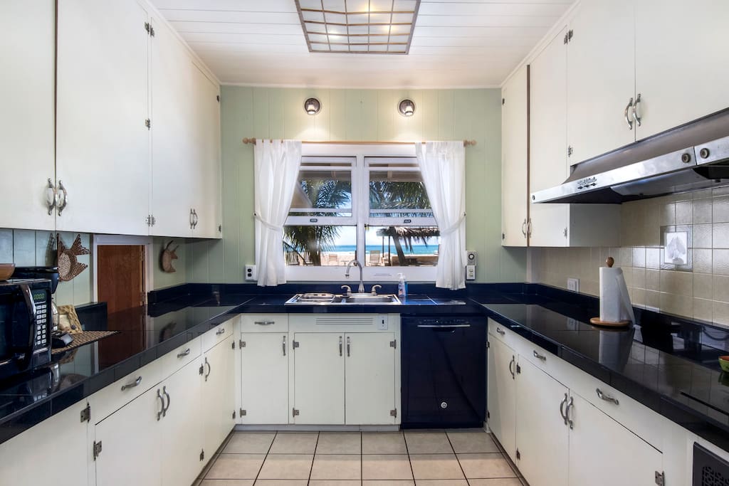 Huge Kitchen with 6 burner glass-top range, black granite countertops, and Oceanview