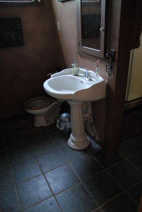 Second bathroom. Glass doors to walk in shower visible at right.