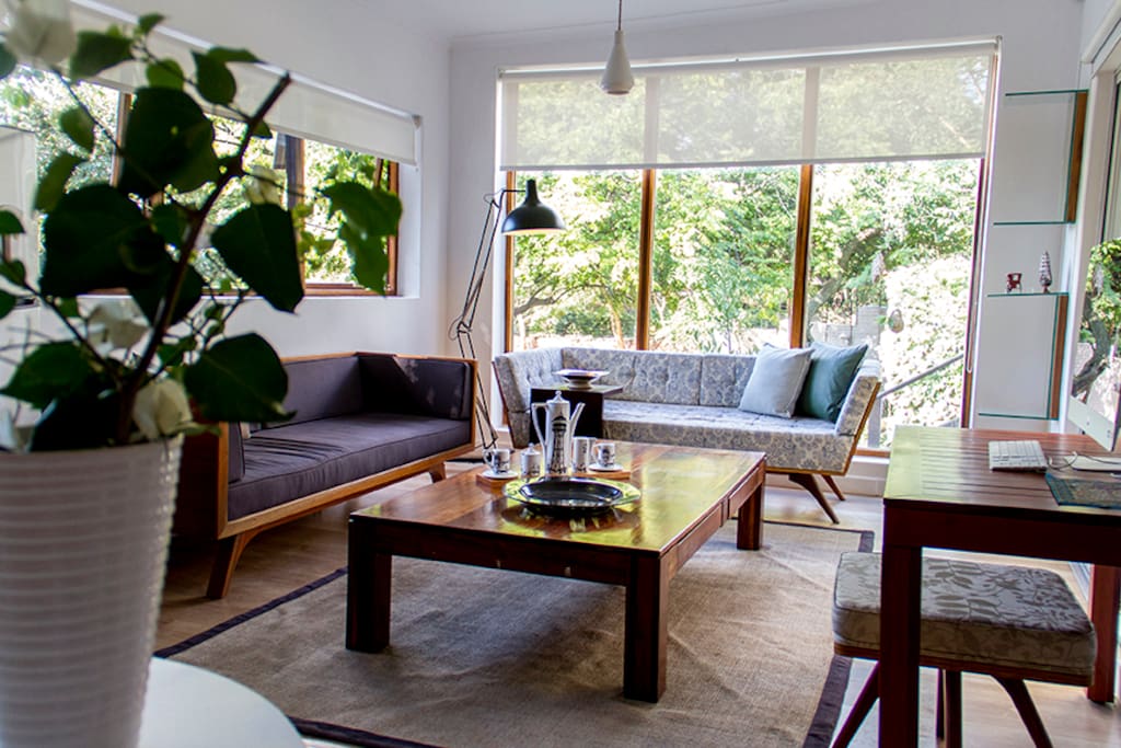 View of lounge area with retro designer furniture and generous coffee table. Full satellite service as well as fiber and smart TV.