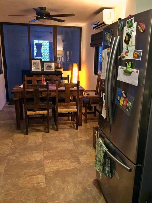 Open plan living, dining to kitchen.