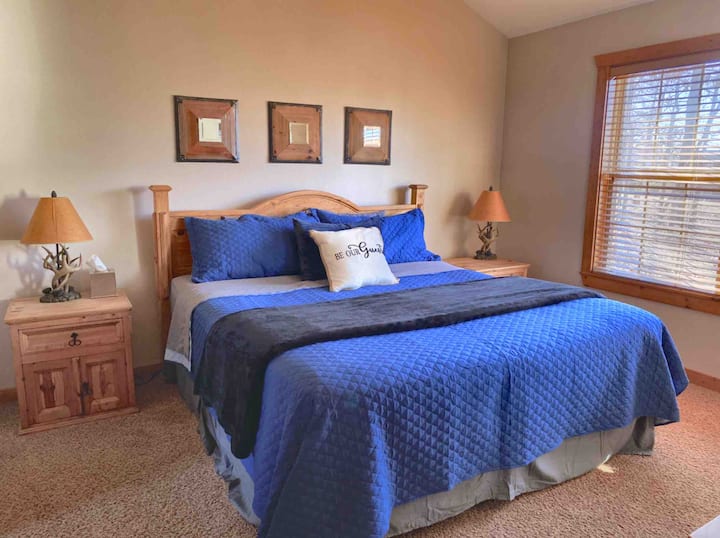 The main bedroom is outfitted with a comfortable king sized bed. 
