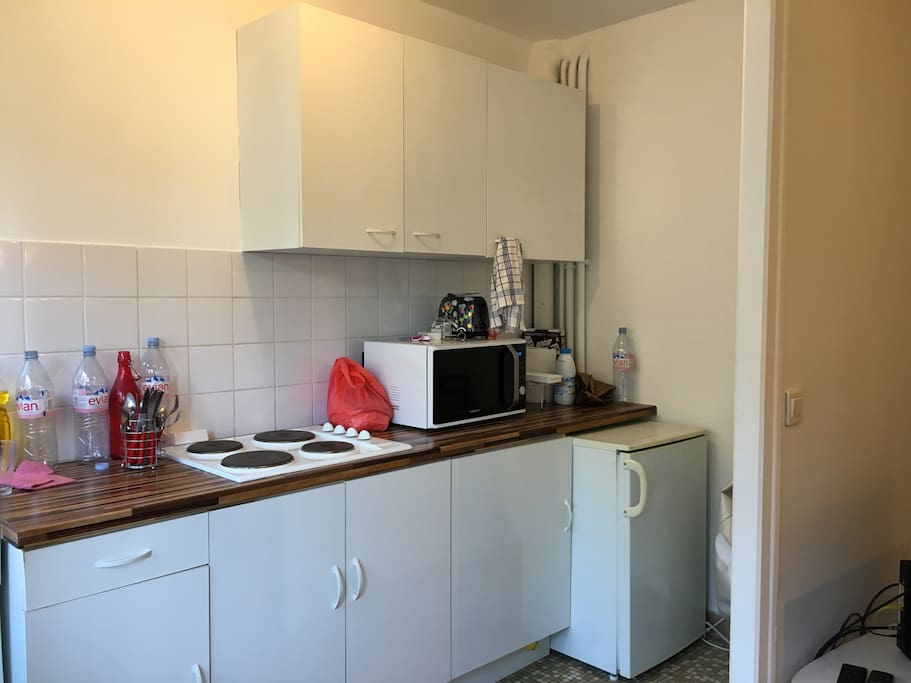 Kitchen with microwave, mini-fridge and toaster.