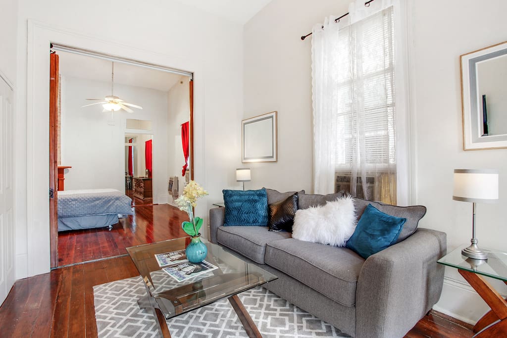 Large front room with pocket doors that lead straight into bedroom