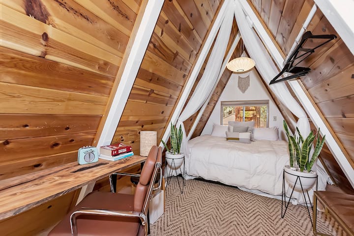 Loft area with king size bed and desk for laptop.