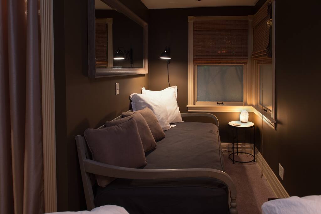 Cozy twin daybed or spot to lounge. Is located inside of the only bedroom, off to the side