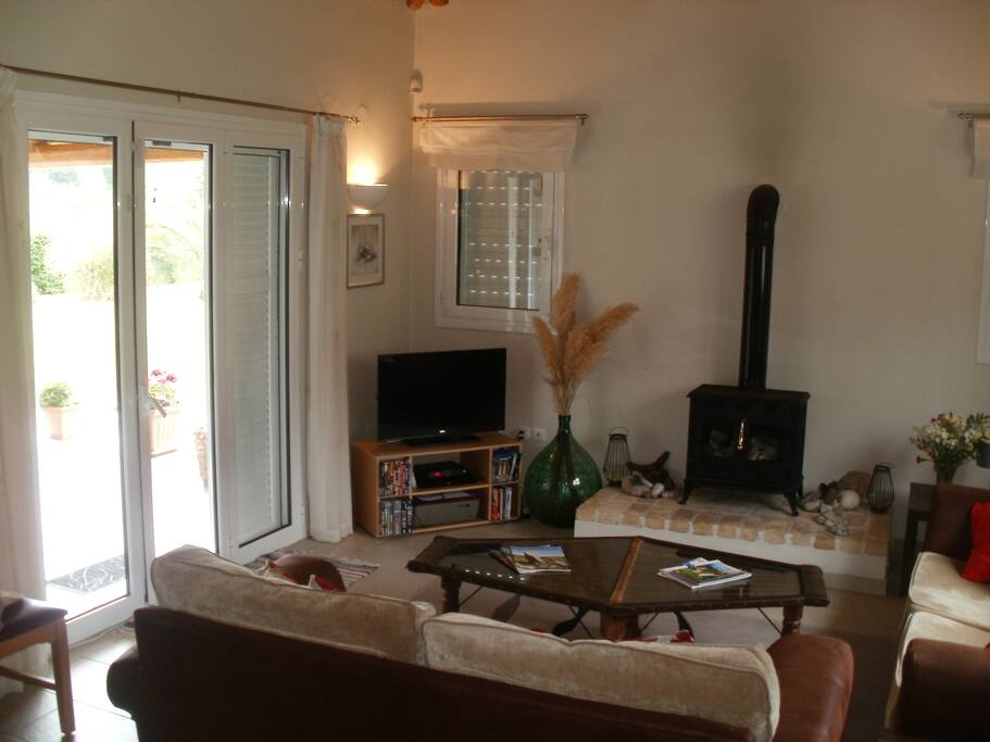 The light and airy living-room leading out to the patio area, pool and garden