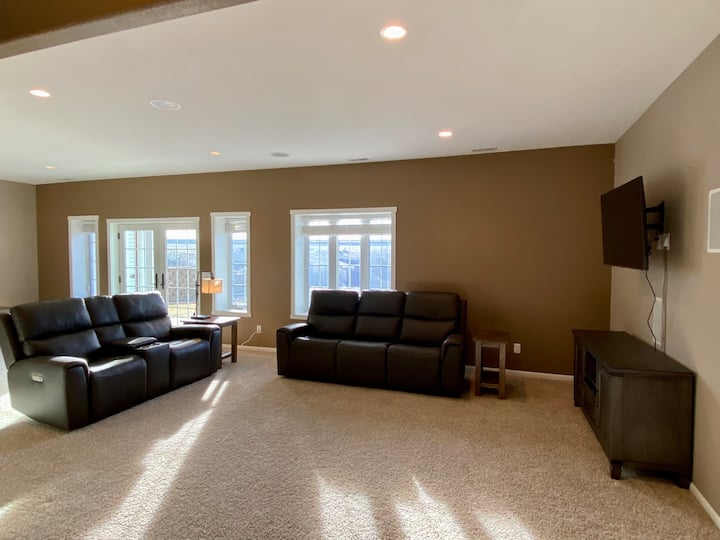 Downstairs Living Room - Reclining sofa and love seat, TV, and walk out patio. 