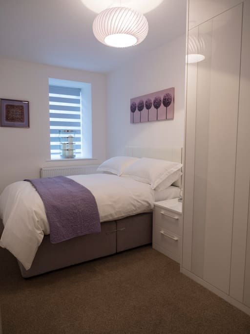 Bedroom with fully fitted wardrobes.