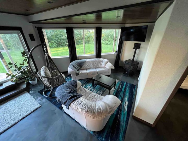 The basement living room has a tv and a wood pellet stove

This setup is brand new as of summer, 2022