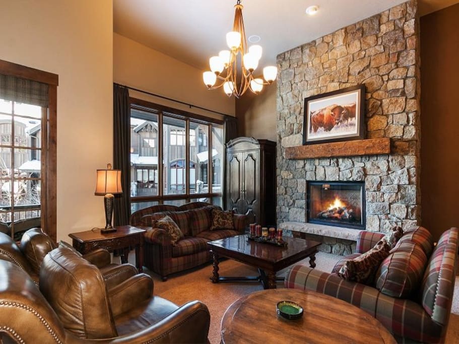 Great room with TV in armoire, gas fireplace, and wet bar.