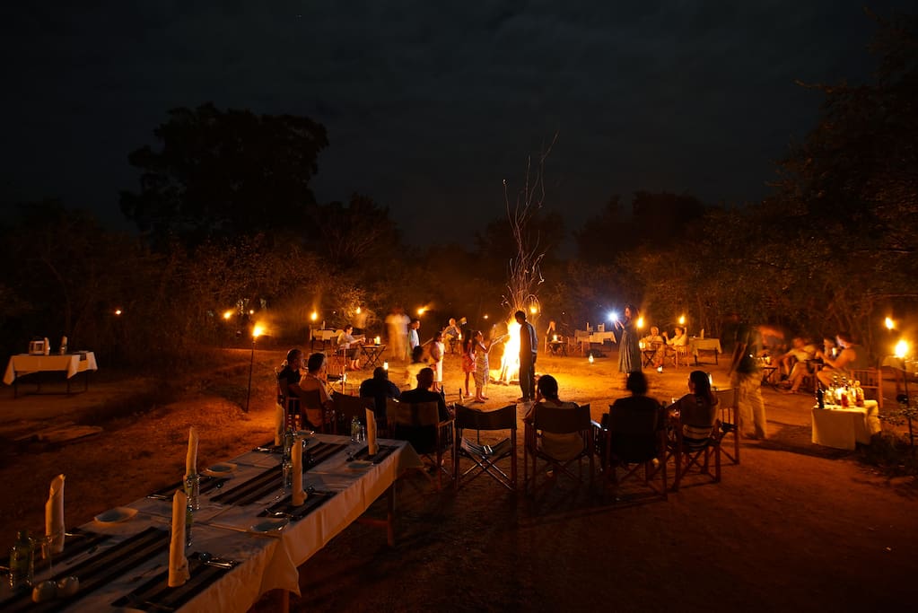 Dinner setting around the campfire