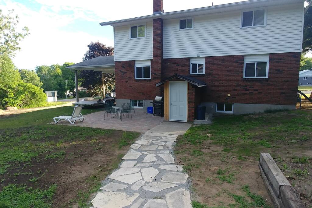 Back of the house and patio area. Patio area with gas bbq and table and chairs.