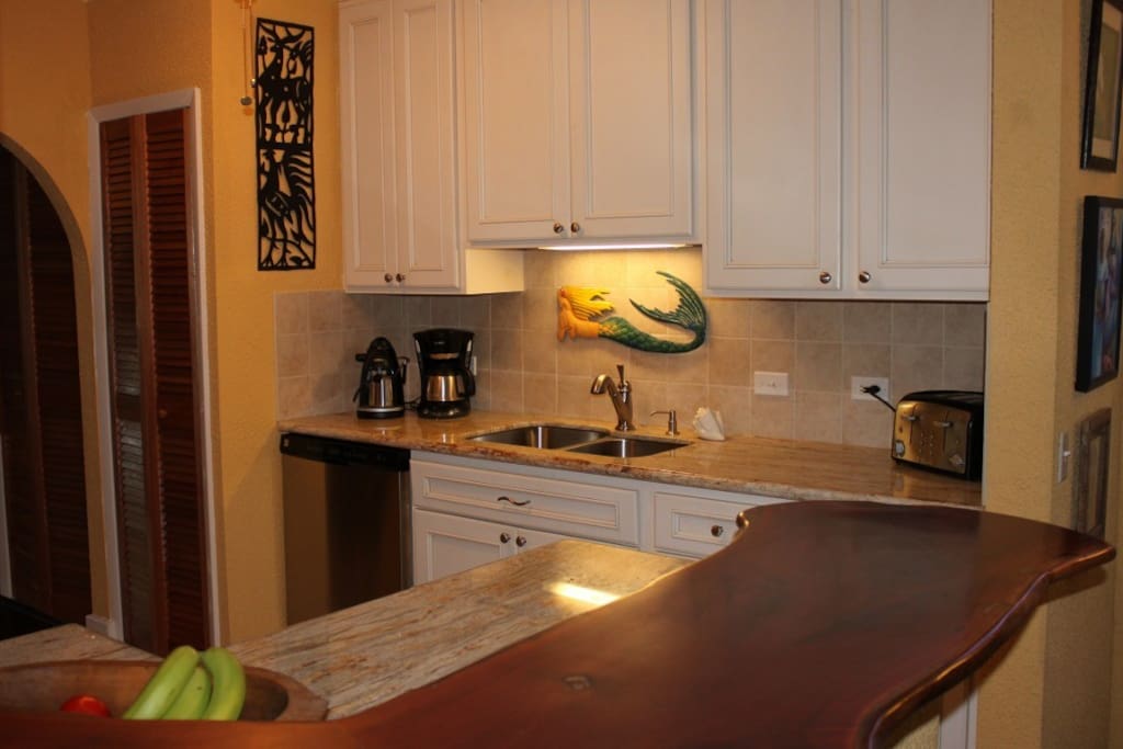 Kitchen w/granite counters and mahogany bar