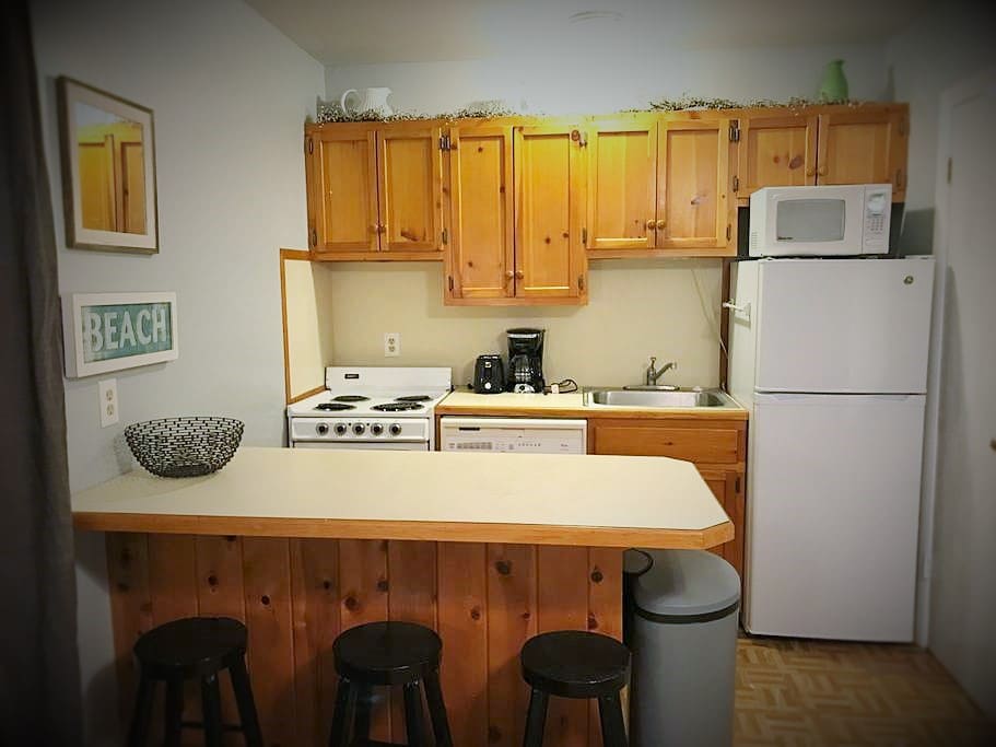 Full kitchen with stove, oven, dishwasher, refrigerator, toaster, coffee pot, microwave and fully stocked with dishes/utensils.