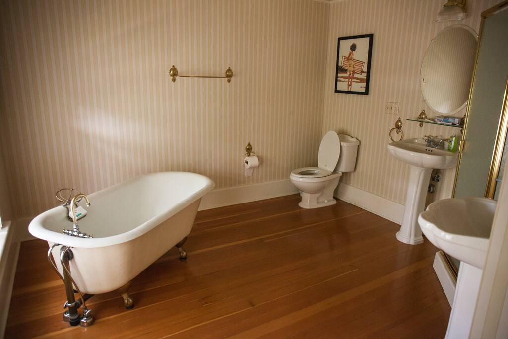 Large Bathroom with old fashioned tub and corner full shower