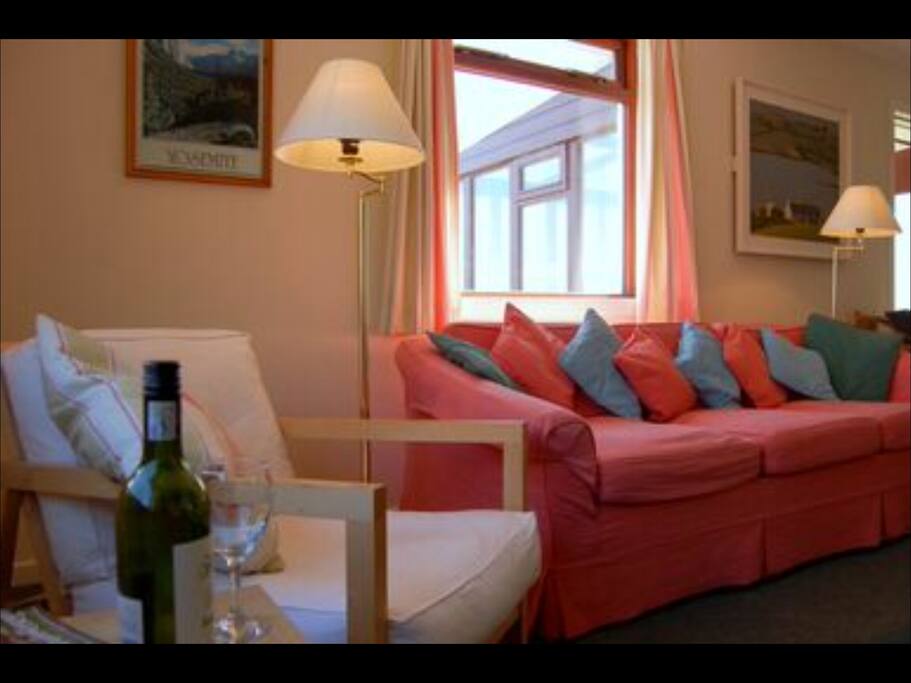 The cosy open plan sitting room has a wonderful open fire
