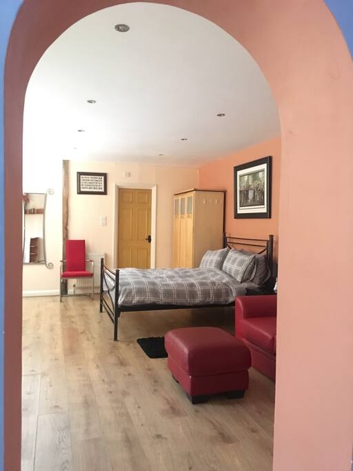 The bedroom, through archway from kitchen