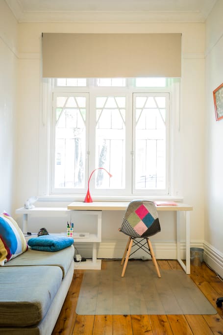 Comfortable work space that looks out through leadlight windows. Seating, reading area captures the morning sun.