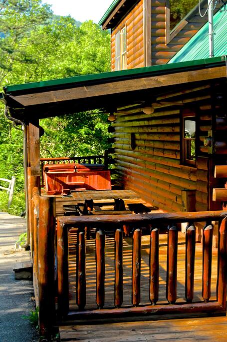 Hot tub area with more seating and ceiling fans for relaxing at night